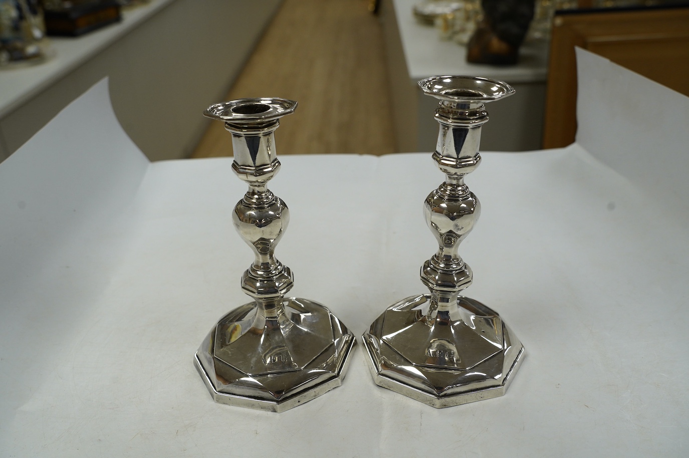 A pair of George V silver candlesticks, by West & Son, Sheffield, 1910, 17cm, weighted. Condition - poor